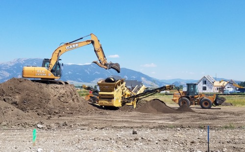 Excavator Loading Dirt in a Dump Truck